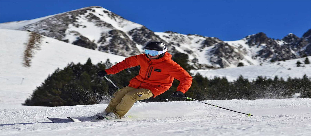 Man skiing quickly down Aspen Mountain Ski hill in Aspen, Colorado during winter