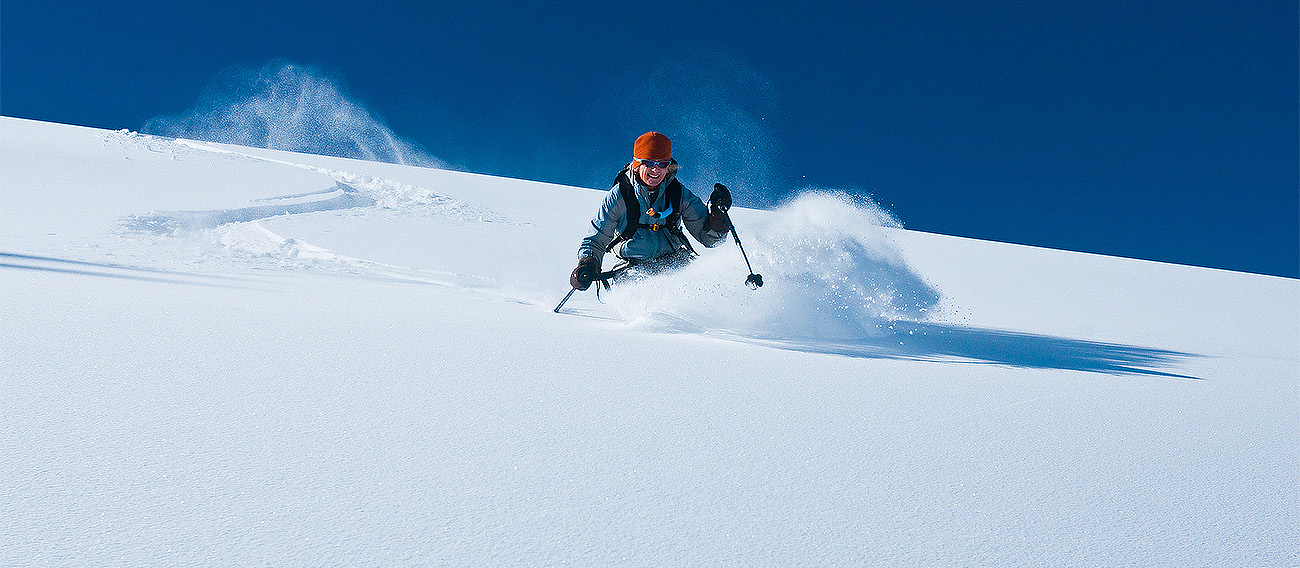 Woman skiing downhill through snow in Aspen Snowmass